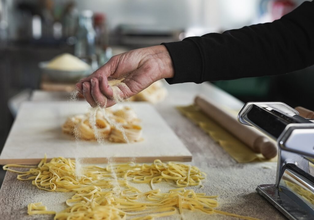 Woman working inside pasta factory - Fresh made taditional italian pasta